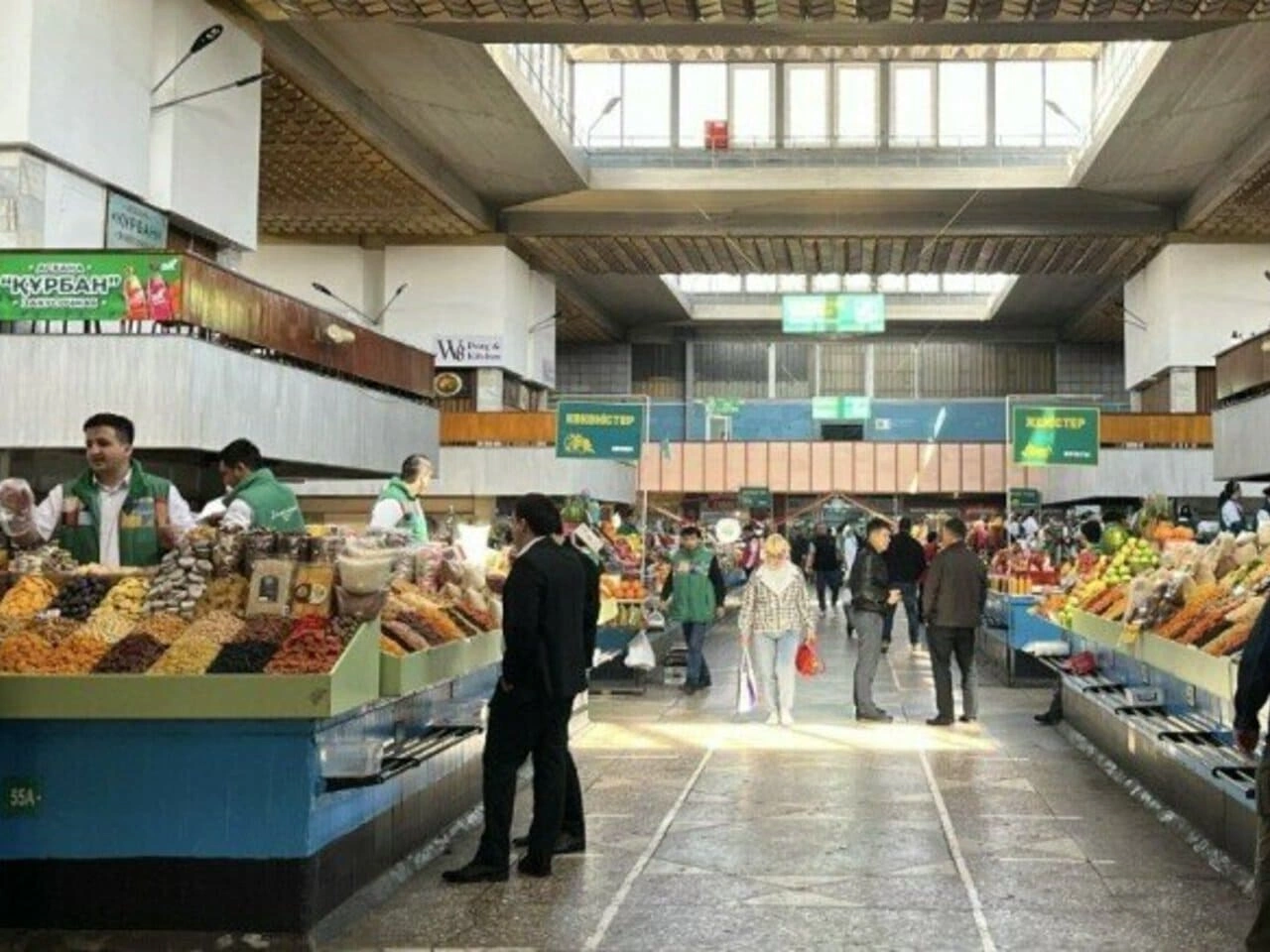 Vendors selling dried fruits and nuts inside the Green Bazaar, Almaty