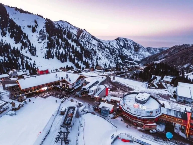 Aerial view of Shymbulak ski resort with snow-covered mountains at sunset