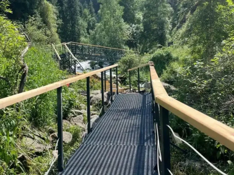 Alma Arasan area view with snowy mountain ridge and dense pine forest near Almaty