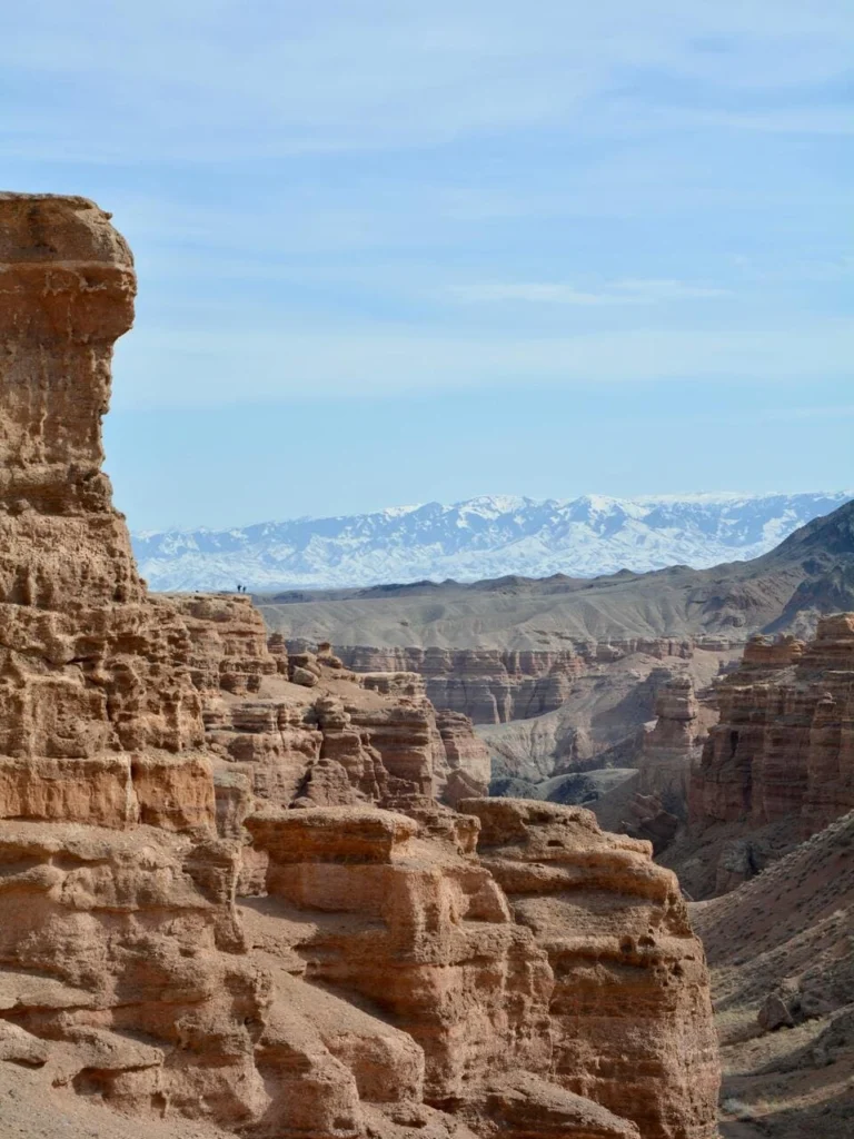 Tourists exploring the red cliffs of Black Canyon near Almaty