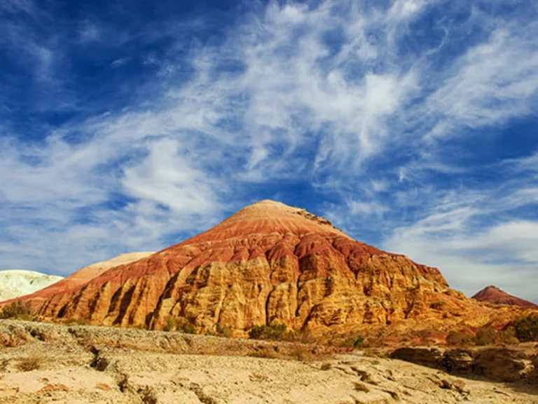 Red and yellow Aktau mountains in Altyn Emel National Park under blue sky