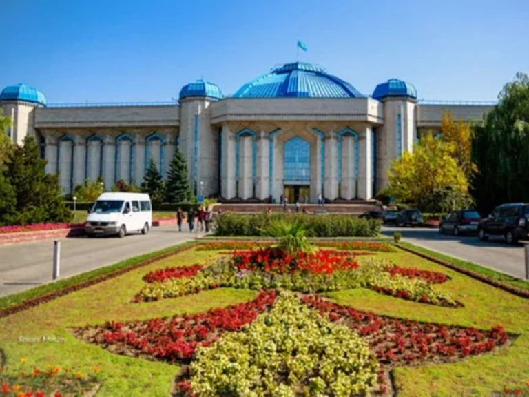 Central State Museum of Kazakhstan Tour 1 Front exterior view of the Central State Museum of Kazakhstan in Almaty with blue domes and landscaped garden.