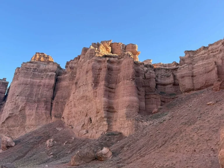 Panoramic drone shot of Charyn Canyon and the winding Charyn River cutting through the desert cliffs.