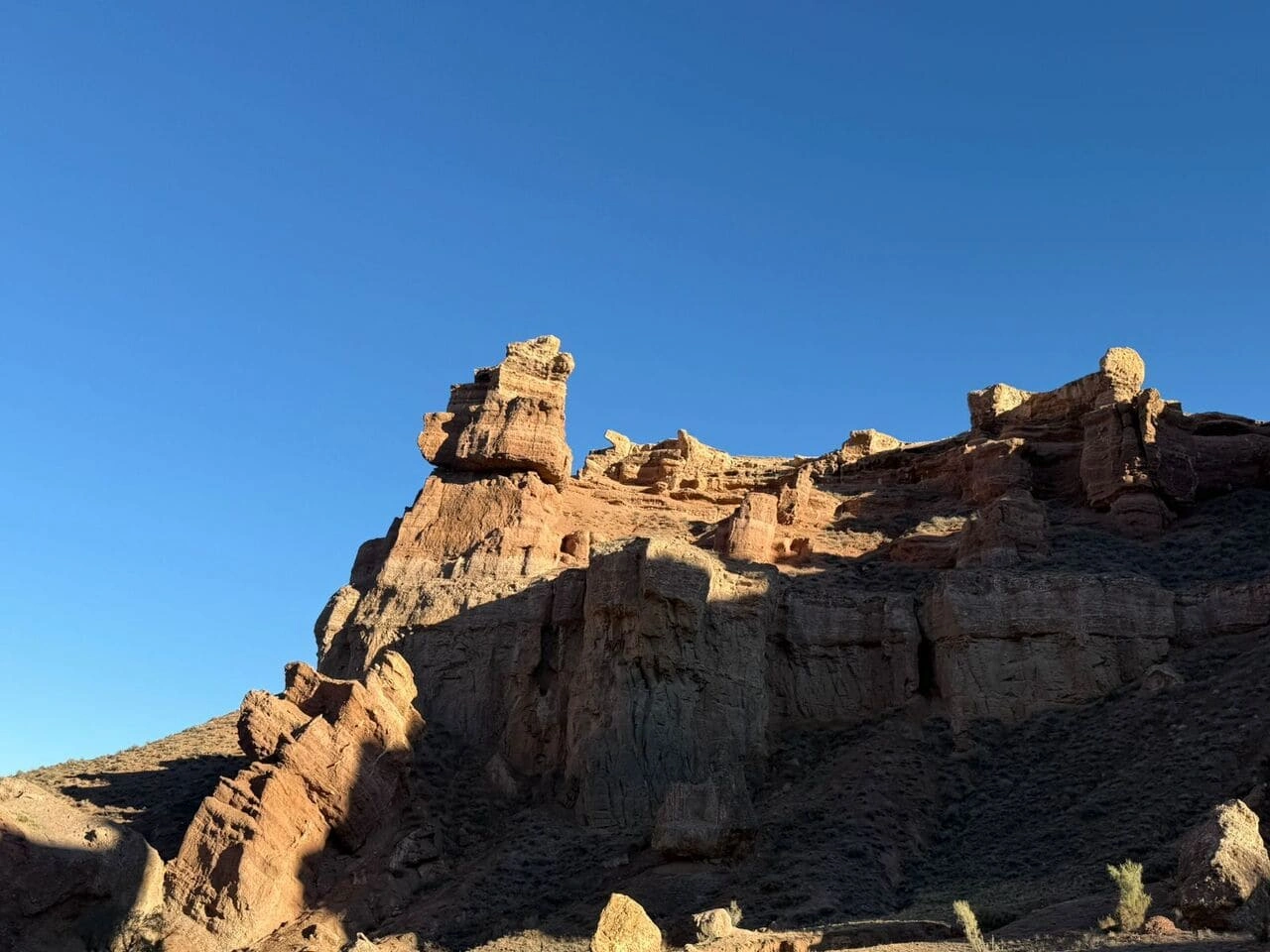 Kazakhstan’s Charyn Canyon at golden hour with sunlight highlighting the rock formations.