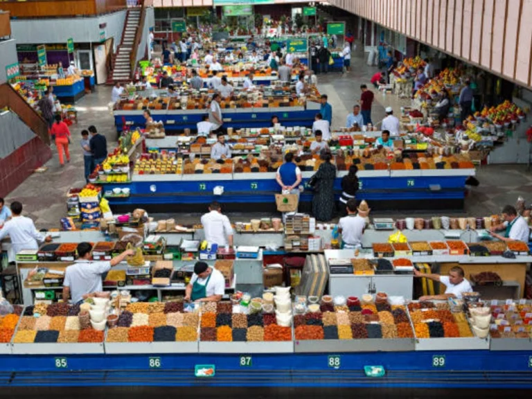 Upper-level view of the busy Green Bazaar in Almaty with spice and dried fruit stalls.
