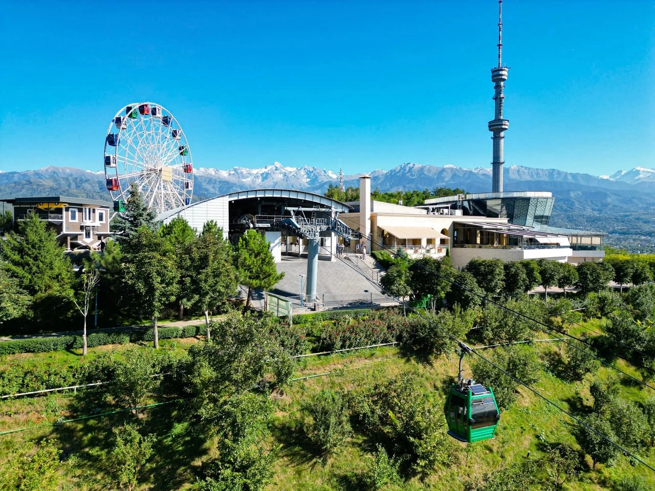 Kok Tobe Park with ferris wheel, observation deck, and Kok Tobe cable car station overlooking Almaty