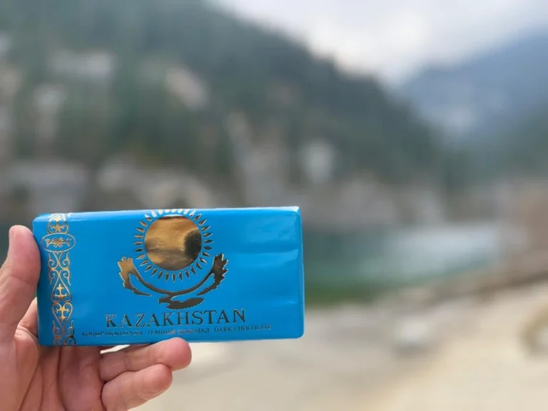 kazakhstan chocolate bar held in hand with mountains in background