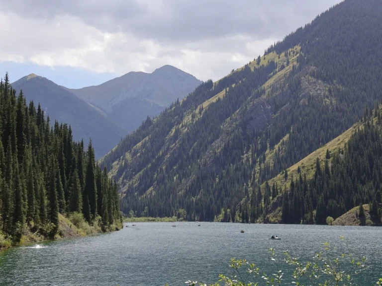 view of kolsay lake and forested mountains in almaty region
