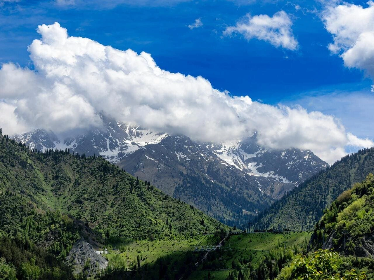 Snowy mountains and green valleys near Medeo in Almaty Kazakhstan.