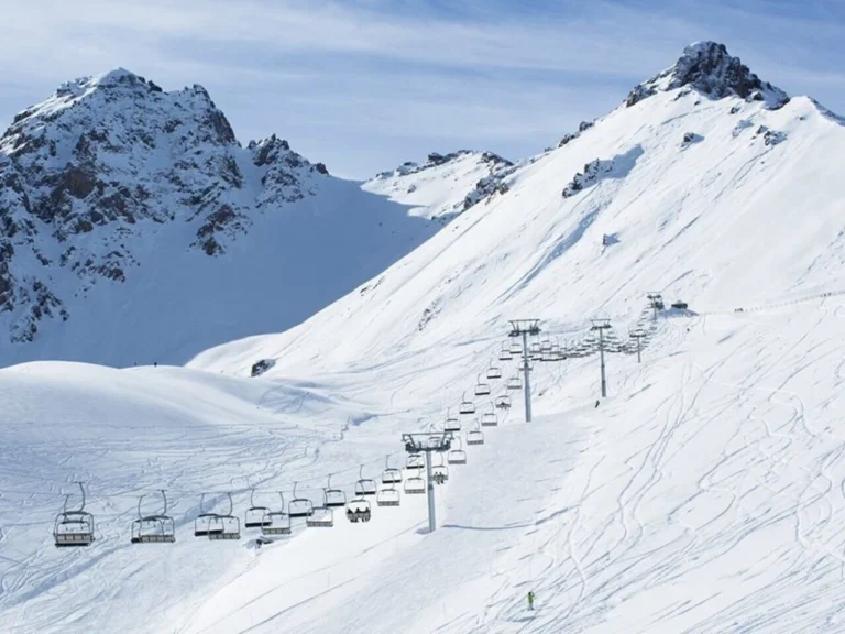 chairlifts and ski slopes at shymbulak ski resort with snowy mountain landscape